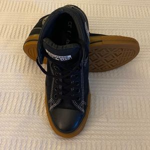 Converse Chuck Taylor med tops in Black, white thread, gum colored rubber soles